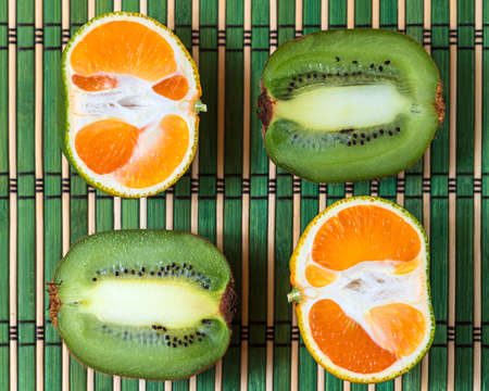 Citrus fruits background orange mandarin kiwi. Flatlay composition. Top viewの写真素材