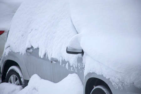 A car under the snow. Heavy snowfallの写真素材