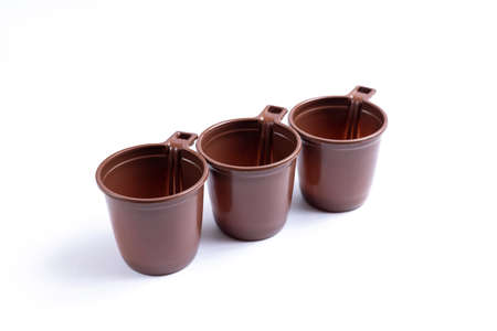 Brown plastic cups isolated on white background.の写真素材