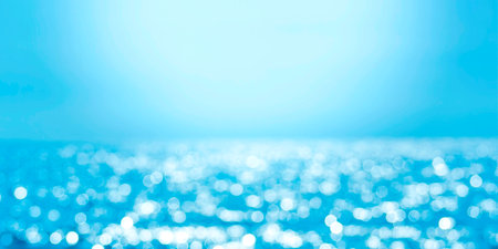 Delicate blue texture bokeh sea. Summer background. Blurry blue bokeh glare on the water on a sunny day. Banner concept travel.の写真素材