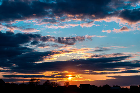 Cumulus sunset clouds with sun. Beautiful sky with clouds on the summer evening.の写真素材