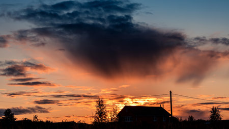 Sky background on sunset over village. Nature composition. Summer background.の写真素材