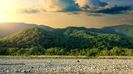 Summer sunset or sunrise over green mountains.の写真素材