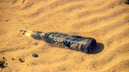 A bottle on the sand. Ecological disaster.の写真素材