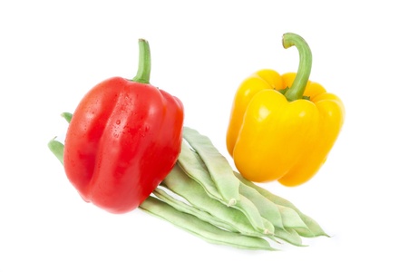 Green beans with yellow and red peppers on a white backgroundの写真素材