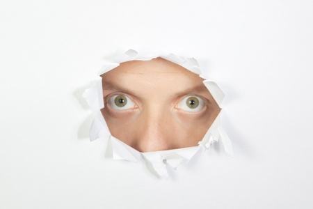 A terrible sight through the hole in the paper.の写真素材