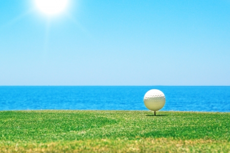 Golf ball on a stand in the background of the ocean  Portugal の写真素材
