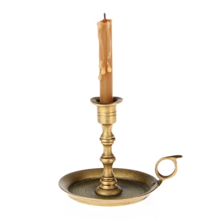 Candle on the old brass candlesticks on a white background の写真素材