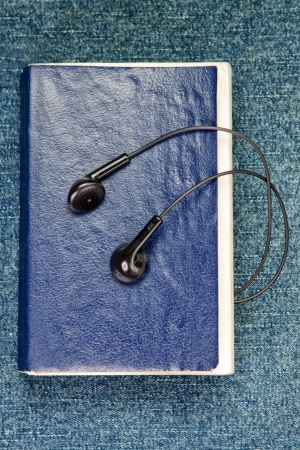 Listen to the book. On the background of jeans.の写真素材