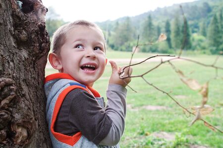 Boy child playing outdoors branch 