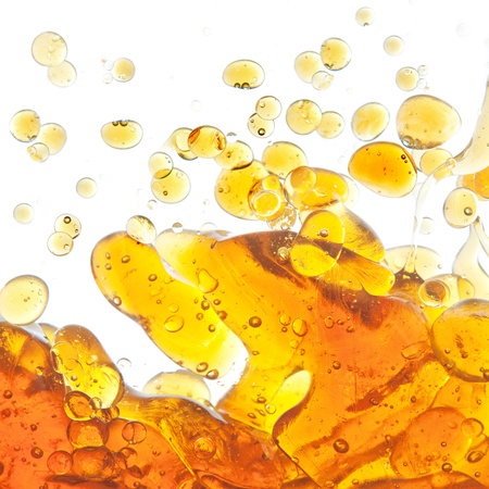 The texture of the bubbles of oil in an abstract form in the water. On a white background.