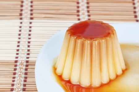 Close-up of yogurt pudding on a plate on decorative wooden napkin の写真素材