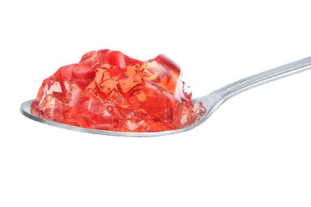 A spoon full of red gelatin  On a white background の写真素材