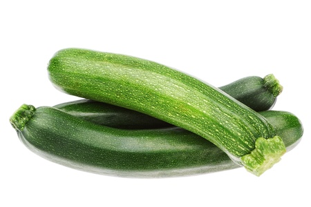 Three vegetable zucchini in a stack on a white background の写真素材