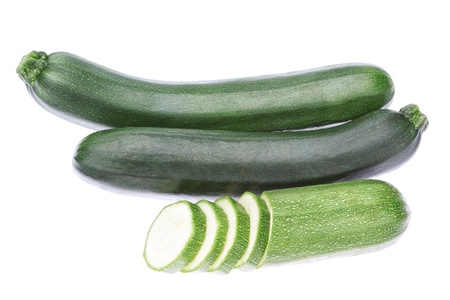 Three vegetable zucchini cut into pieces  On a white background の写真素材