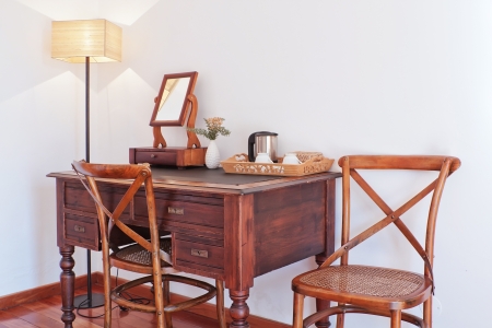Classic antique table with a set of cups, teapot, vase and mirror の写真素材