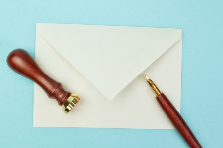 Stationery and office supplies postal envelope on a blue background の写真素材