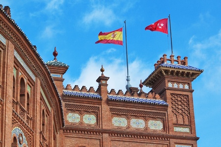 National flags of Spain in Madrid on Pras bullring bulls  Against the blue sky 