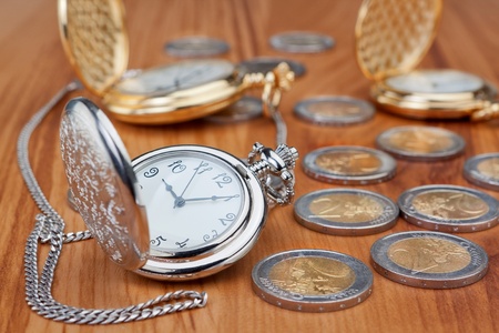 Group pocket watch against the background of euro coins の写真素材