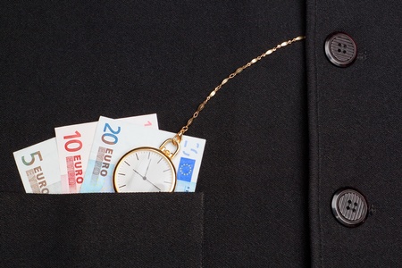 Concept photo of a pocket watch in a jacket on a background of money euro 