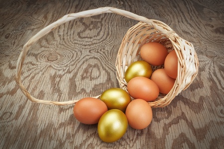 Easter eggs in an inverted basket. Group of golden eggs.の写真素材