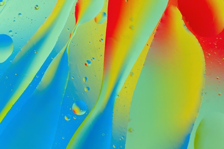 Decorative forms of oil on a colorful background. Abstraction.