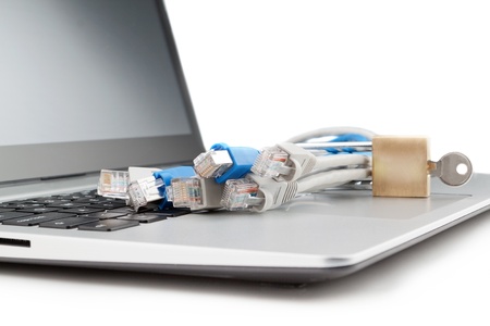 Modern notebook and a group of network cables with lock close-up.
