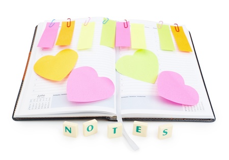 Notebook office organizer and reminder stickers with a ballpoint pen. With the word notes.の写真素材