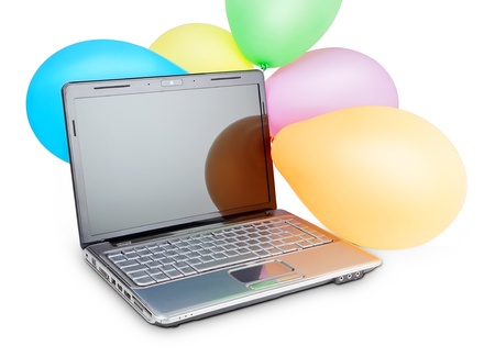 Funny picture carnival rubber balls on a modern laptop. For a birthday or holiday.の写真素材