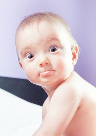 Beautiful portrait of a baby girl with a pretty face. In the warm colors.の写真素材