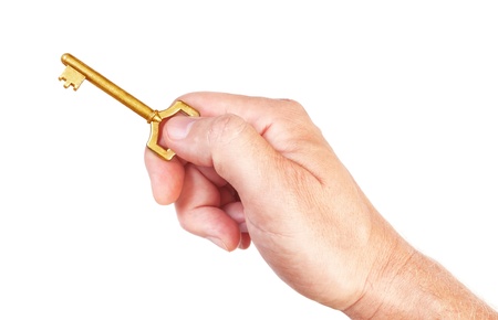 Golden key in hand to open their own home rich. On a white background.の写真素材