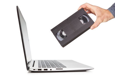 The concept of a video cassette technology in the hand compared to the laptop. Progress on...