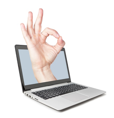 All perfectly, the hand pops out of the laptop. Concept idea.の写真素材