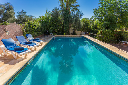 Summer outdoor pool in the garden. With sunbeds for tourists.の写真素材