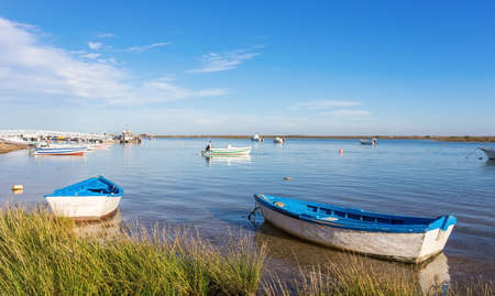 Old fishing boats in the bay. Tavira, Portugal.