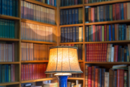 Angle library of old books and knowledge. The lamp shade in the foreground.