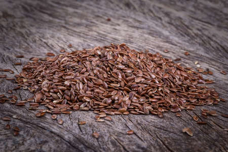 Gorka grain flax close-up. On the texture wooden background.