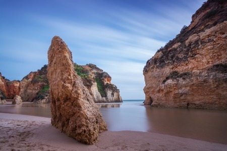 Bay Seascape with a rock in the foreground. In a long exposure.