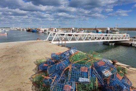Traps for fish and shellfish on the dock. The ships in the background.の写真素材