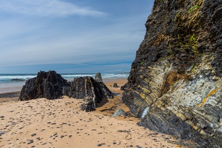 Rocky coast with sea views. The stream flows down from the mountains.の写真素材