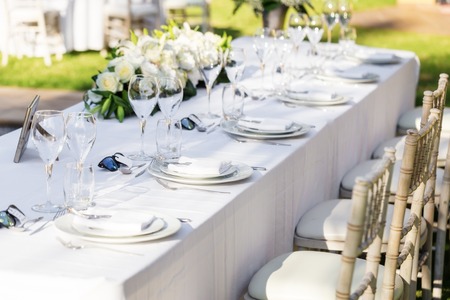 Wedding table decorations. Close-up. Flowers plates utensilsの写真素材