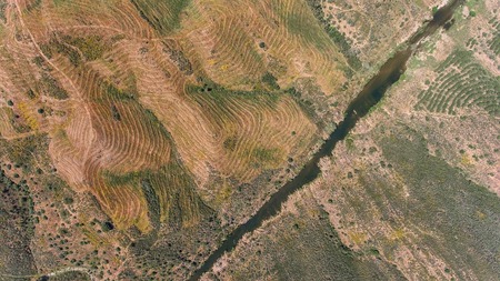Aerial. Terrain of Alentejo, shooting from the drone.. Road to the village of Mertola.