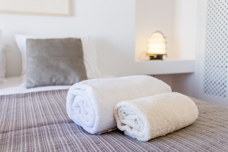 White towels on the bed in bedroom. Close-upの写真素材