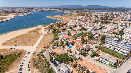Aerial. The village of Ferragudo overlooking city of Portimao.