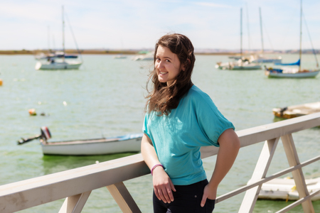 Emotional portrait of a girl on a dock near the sea. Portugalの写真素材