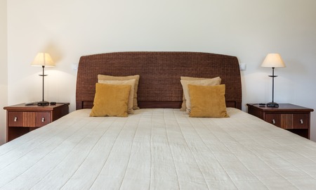 Bedroom in modern style with bed and pillows. Front view.の写真素材