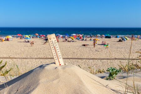 Thermometer for the temperature on the beach, in the summer in the heat. Global warming