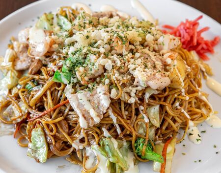 Asian pasta with vegetables, warm japanese sushi dish.