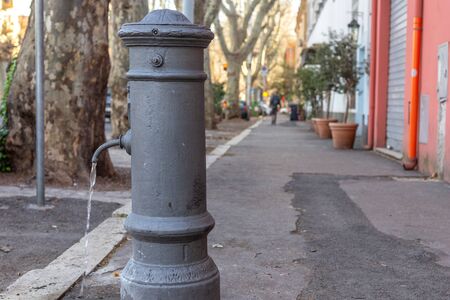 The constant waste of drinking water from a faucet in an Italian city, Romeの写真素材
