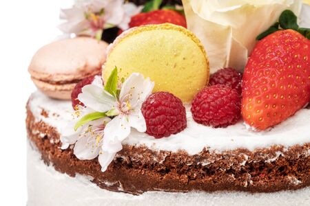 Birthday cake with almond flower fruits and marshmallows.
